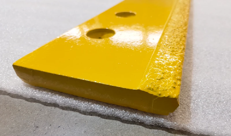 Comparison of a worn steel snow plow edge and a carbide snow plow edge after the same season
