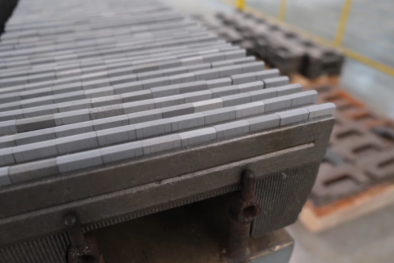 Induction welding station joining tungsten carbide inserts to a steel carrier at the SENTHAI plant in Rayong